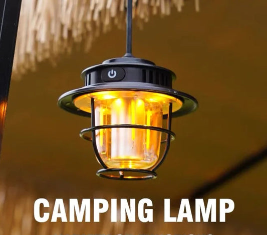 Camping lamp with warm glow and text 'Camping Lamp' against a blurred natural background.